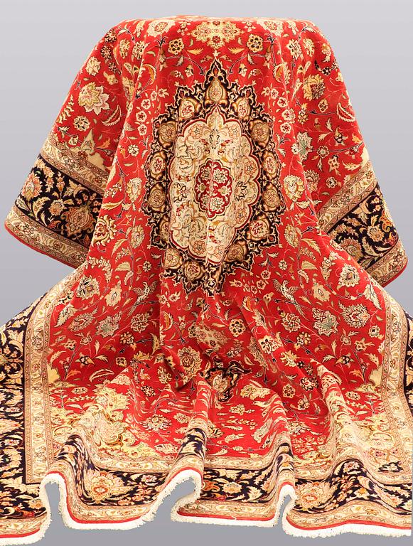 A carpet, Täbriz part silk, 341 x 248 cm.