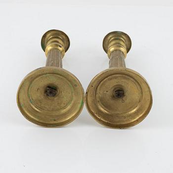 A pair of Empire bronze candlesticks, first half of the 19th Century.