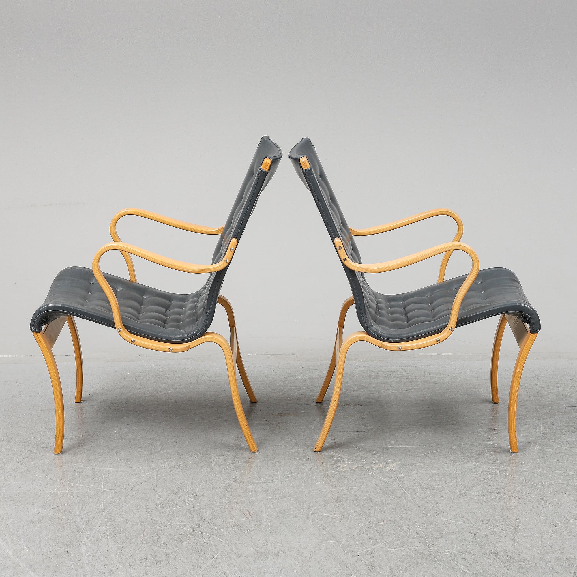 A second half of the 20th Century pair of 'Mina' armchairis by Bruno Mathsson for Mathsson International.