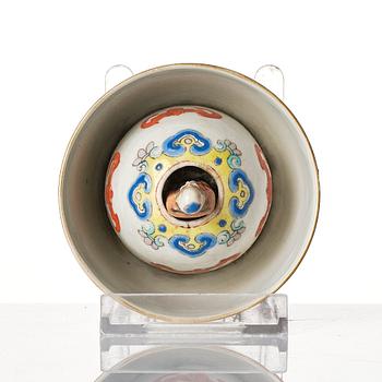 A famille rose 'trick cup' with a little figure, Qing dynasty, 19th Century.