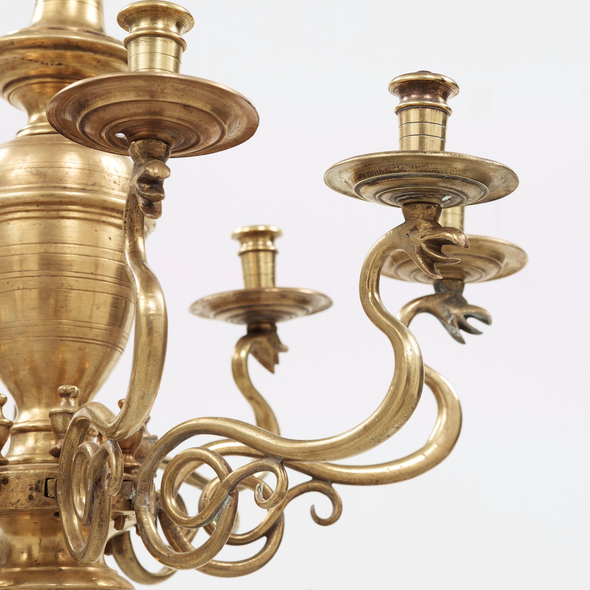 A 19th century eight-light brass chandelier in the manner of Hans Rogiers van Harelbeke.