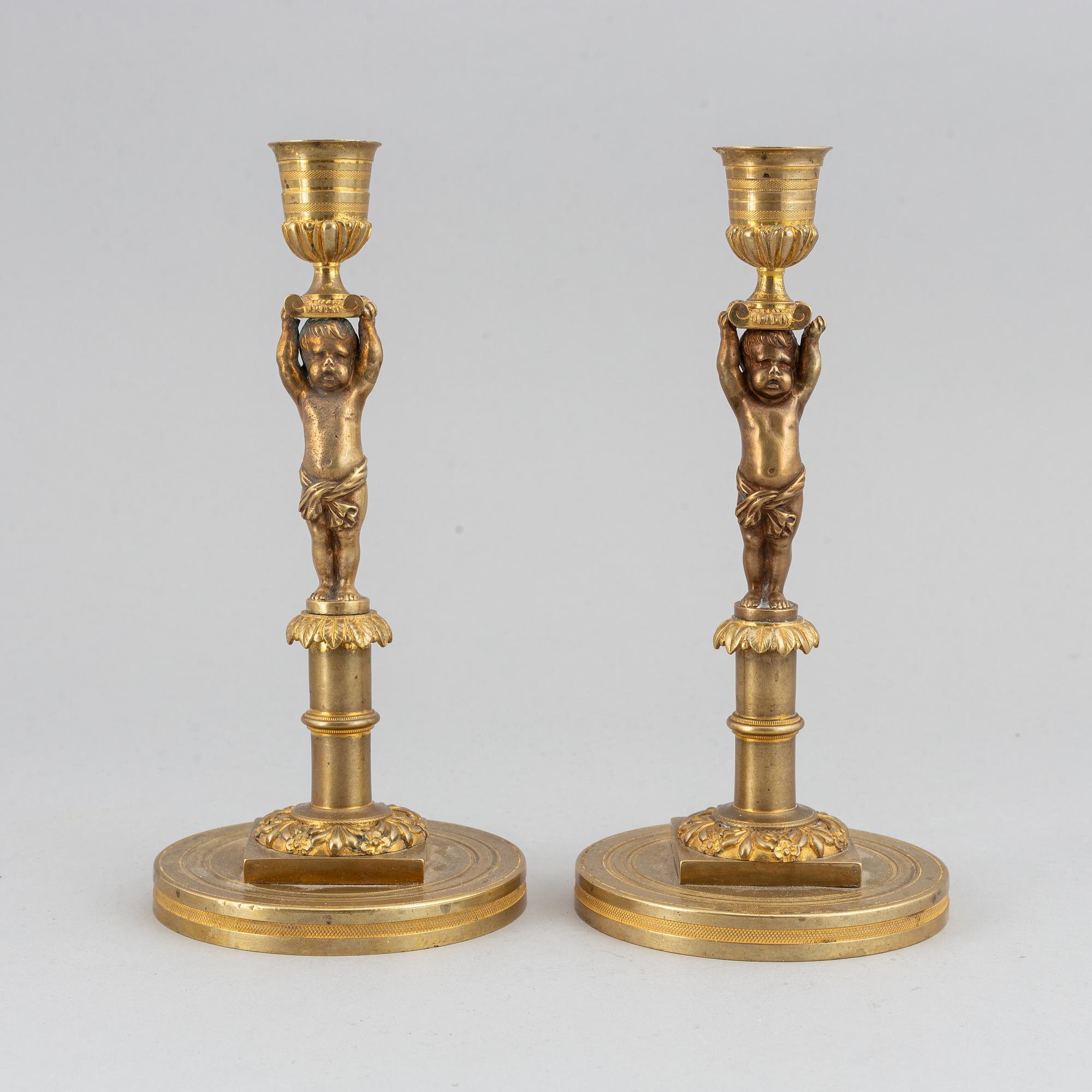 A pair of 19th Century bronze empire style candlesticks.