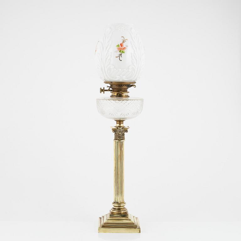 A brass and glass column shaped paraffin lamp, end of the 19th Century.