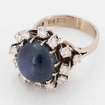 Cabochon-cut sapphire and brilliant-cut diamond cocktail ring.