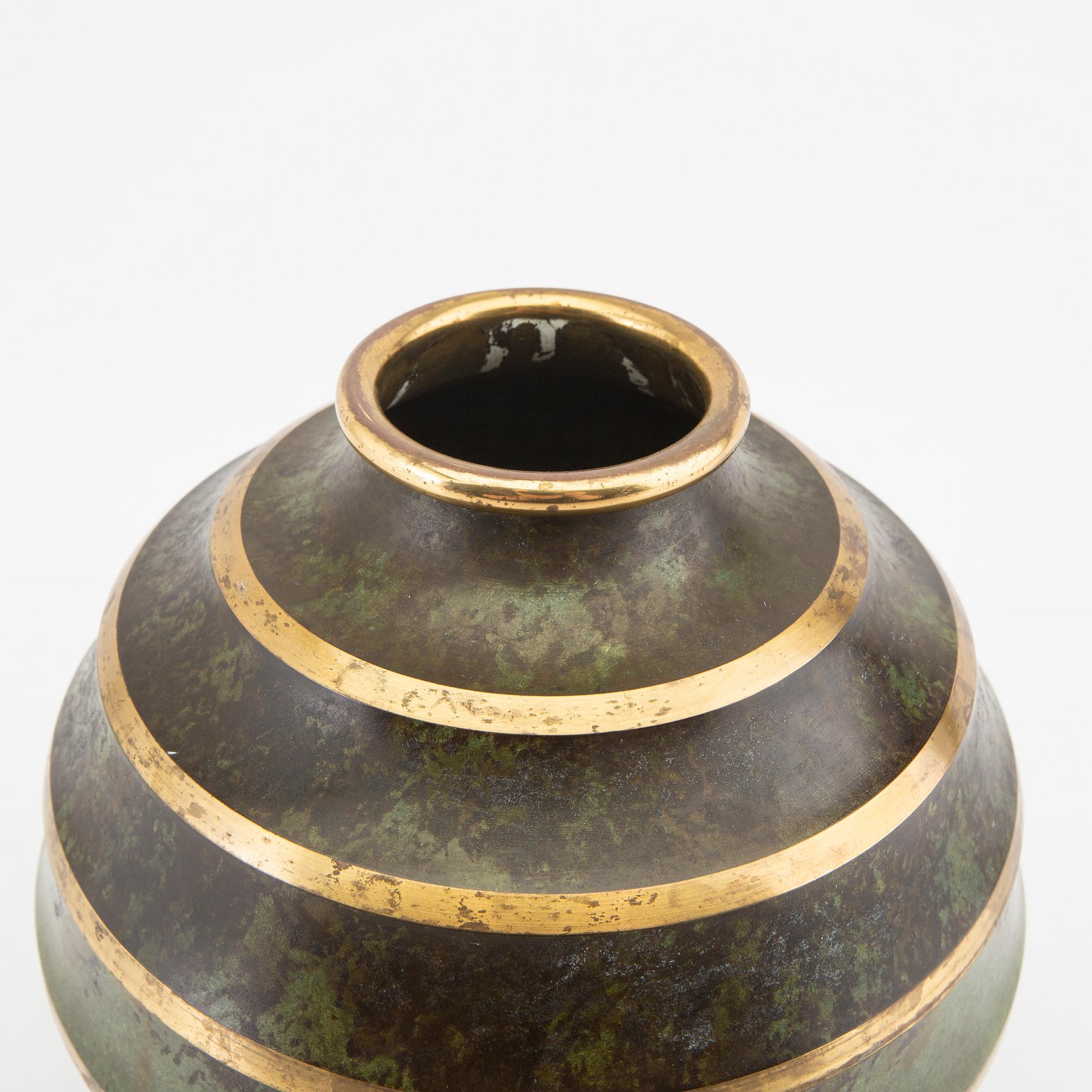 A 1930s metal vase.