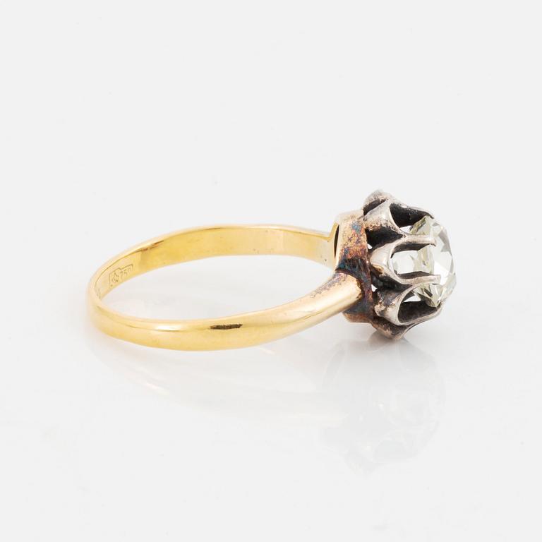 An 18K gold and silver ring set with an old-cut diamond.