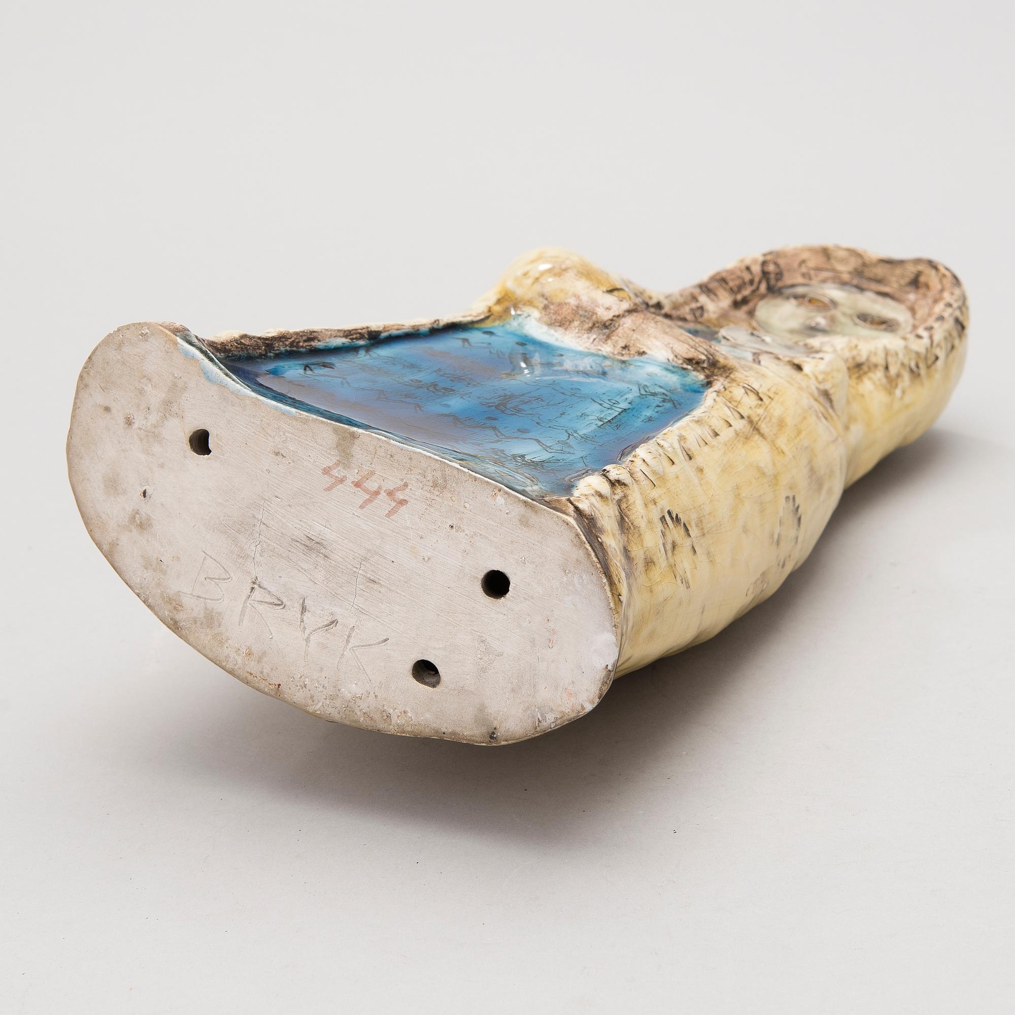 A stoneware figurine signed BRYK.
