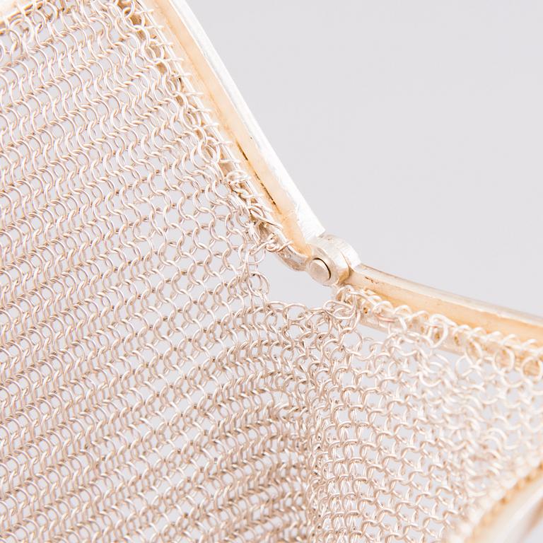 Two silver evening bags and a silver mirror, 1920s-1940s.