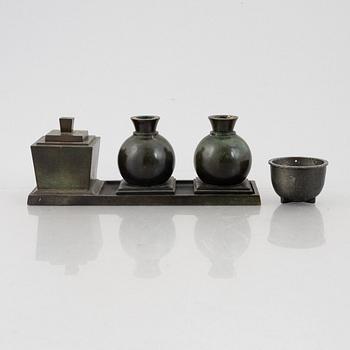 Guldsmedsaktiebolaget, a writing stand and a pair of candle holders, bronze, Sweden, 1920's.