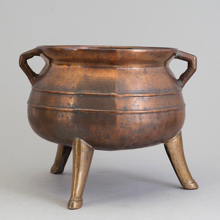 A Swedish 18th/19th century brass pot on three legs.