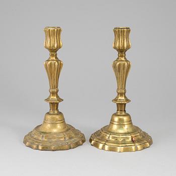 A pair of 18th century bronze candlesticks.