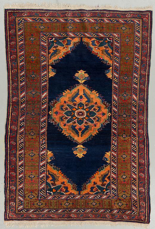 An oriental rug, probably Caucasian. Around 199 x 137 cm.