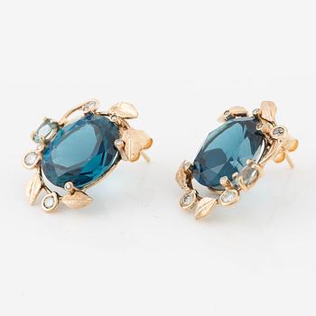 Earrings with blue topazes and brilliant-cut diamonds.