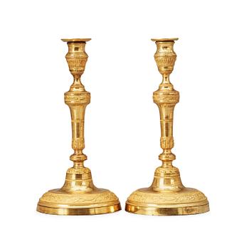 1459. A pair of Louis XVI late 18th century candlesticks.