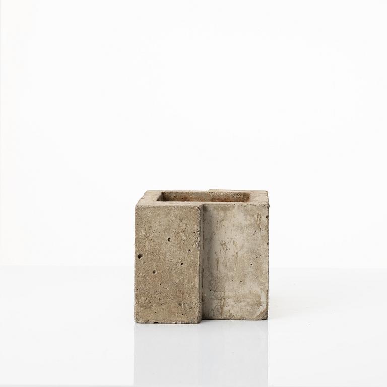 Stina Lindholm, a contemporary concrete planter 'Spira', a concrete flower pot and a wall clock.