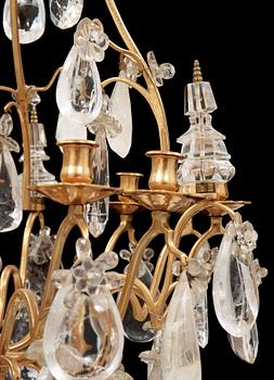 A late Baroque-style rock crystal twelve-light chandelier, circa 1900.