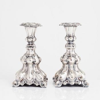 Two similar baroque style silver candlesticks by Kultakeskus, Hämeenlinna 1948 and Hopeatehdas Oy, Helsinki 1953.