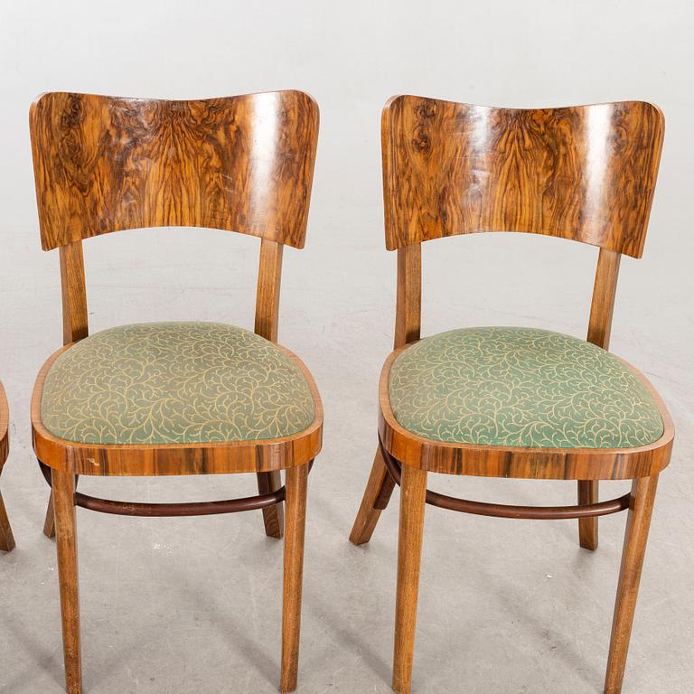 A set of four mid 20th century chairs in walnut.