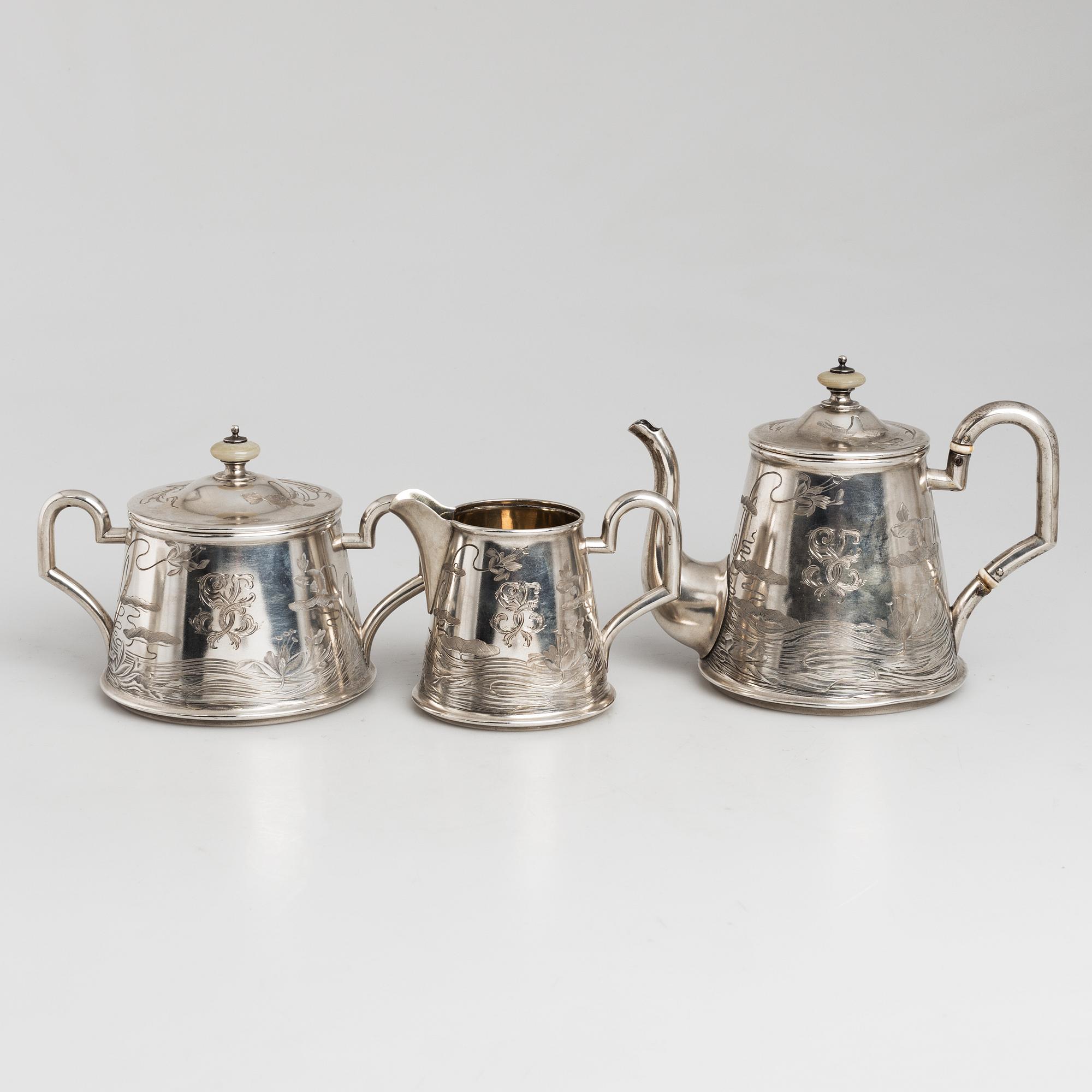 A five-piece Russian parcel-gilt tea set, maker's mark B.A. for Vasili Andrejev or Vasili Akimov, Moscow, 1898-1914.