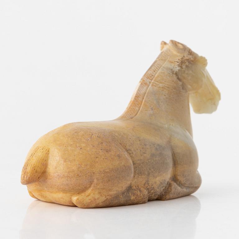 A carved nephrite figure of a reclining horse, 20th Century.