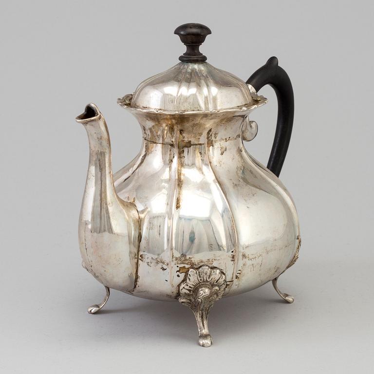 A silver rococo style teapot.