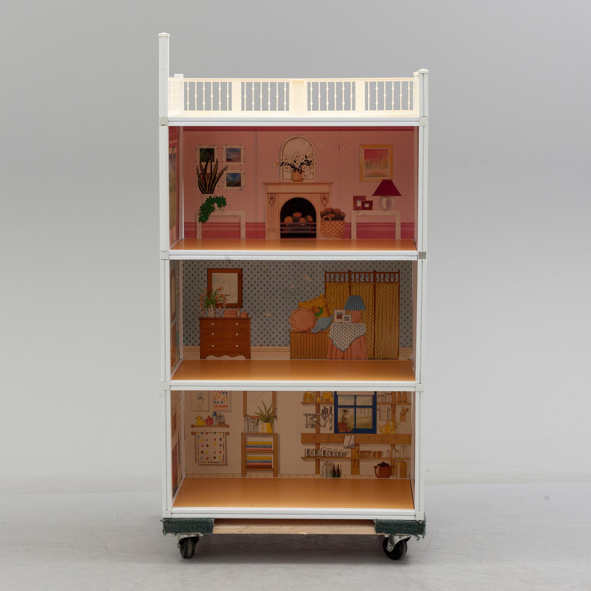 A plastic doll's house with six dolls, furniture and clothes, 20th century.