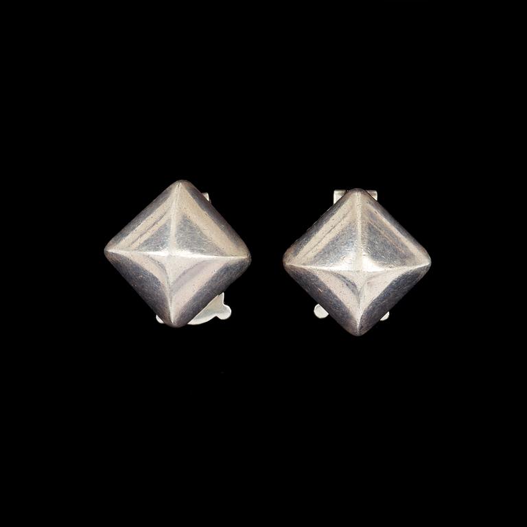 A pair of earrings by Hermès.