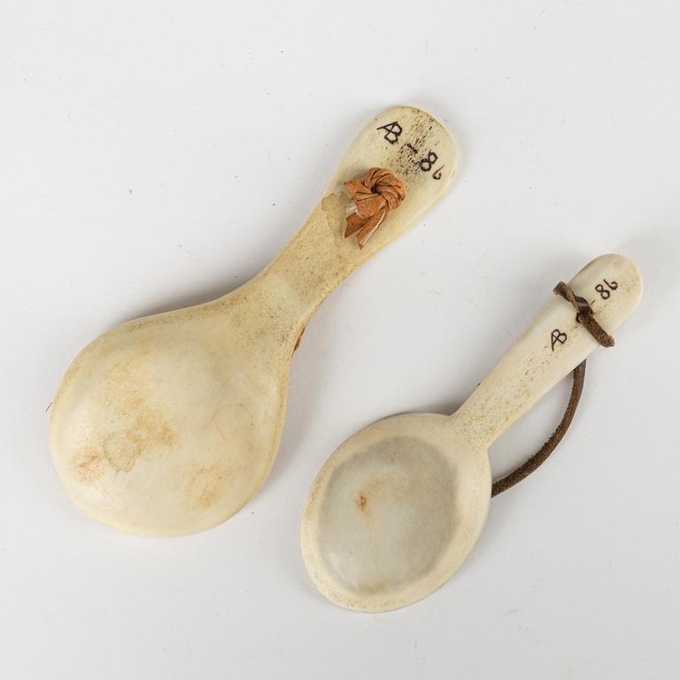 A rendeer horn knife and two spoons, unidentified signature AB.