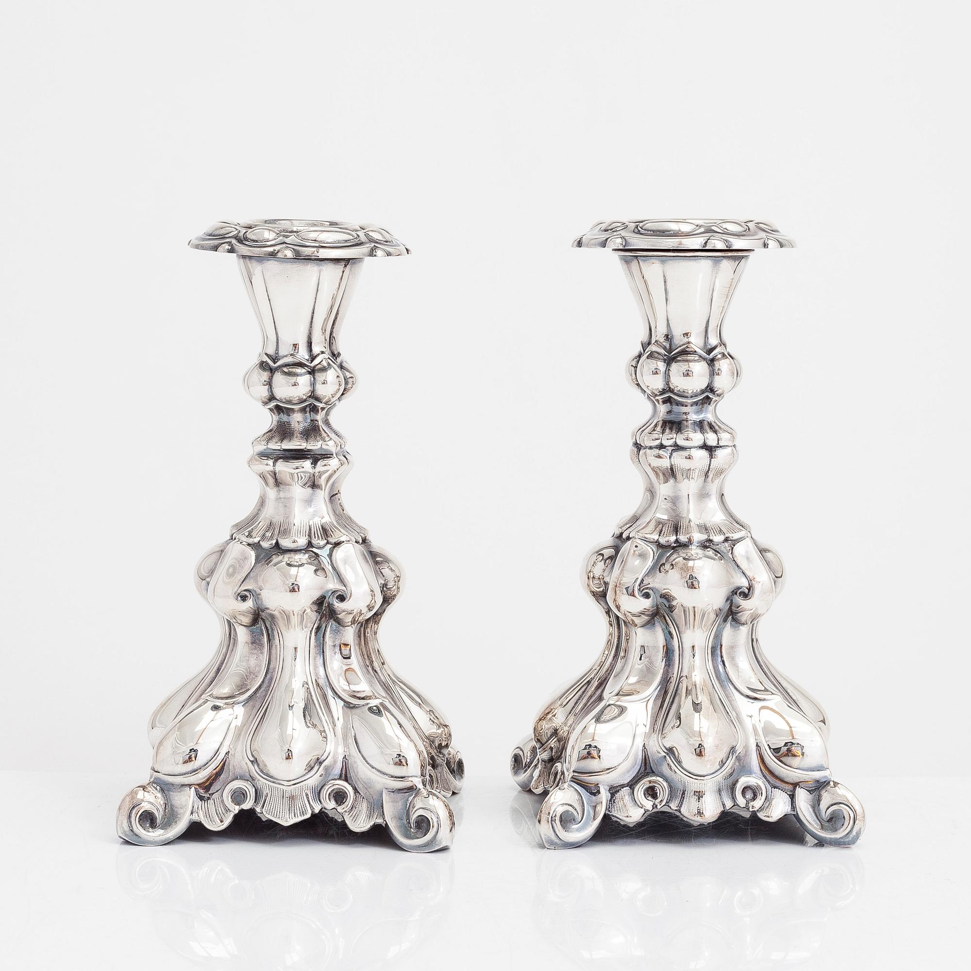 Two similar baroque style silver candlesticks by Kultakeskus, Hämeenlinna 1948 and Hopeatehdas Oy, Helsinki 1953.