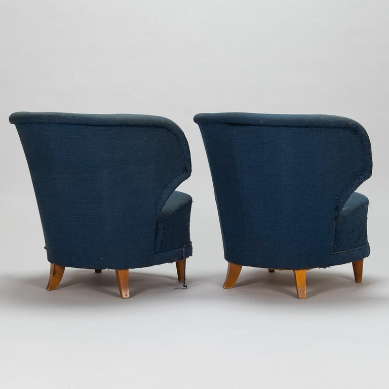 A pair of 1950s armchairs.