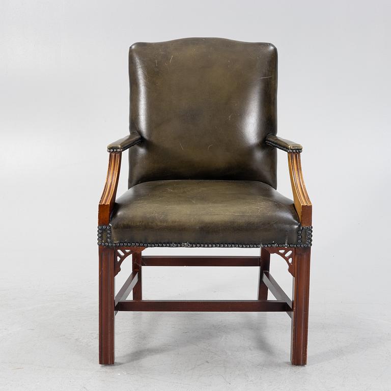 A 20th Century leather upholstered mahogany armchair.