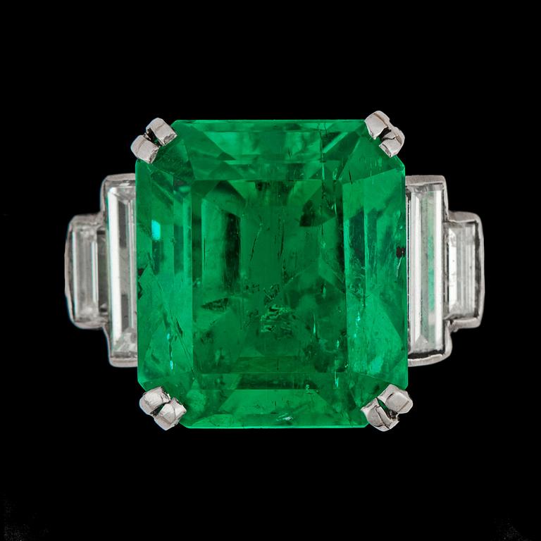 An important step cut Colombian emerald, 8.21 cts, and baguette cut diamond ring.