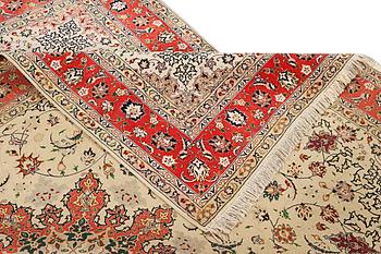 A Tabriz, part silk carpet, c. 300 x 199 cm.