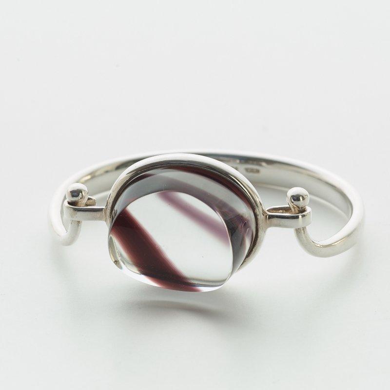 A Torun Bülow Hübe sterling bangle with a cut graal glass lock, ca 2001.
