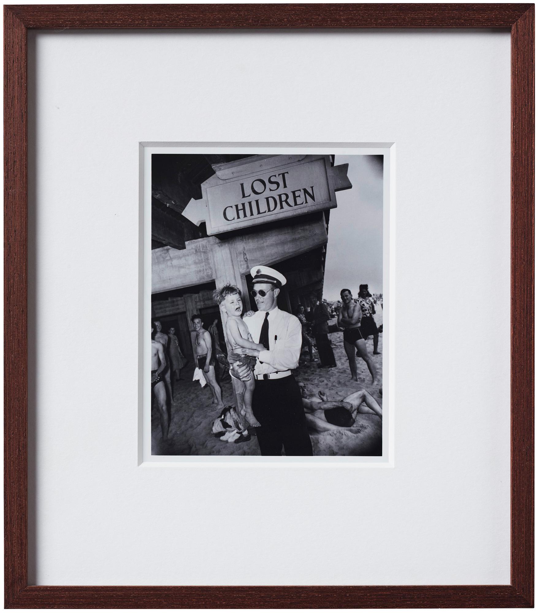 Weegee, "Park Department attendant with lost child, Coney Island, Brooklyn, New York, June 9, 1941".
