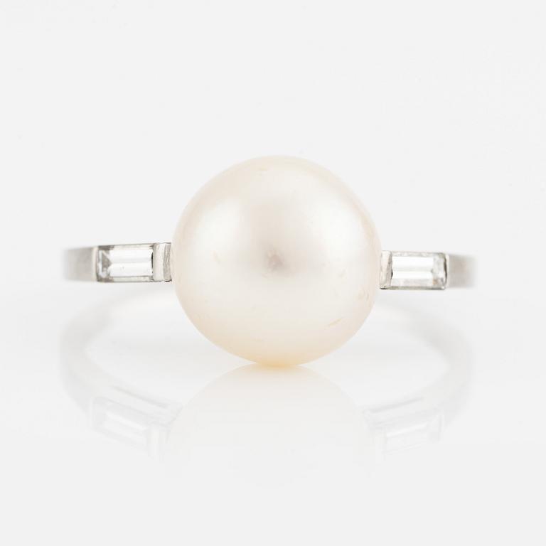 Platinum ring with pearl and baguette-cut diamonds.