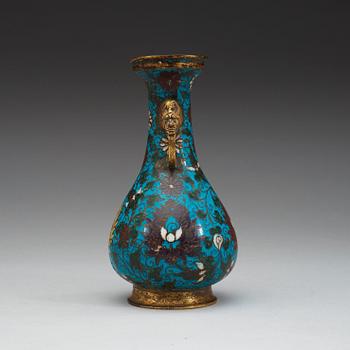 A cloisonné vase decorated with lotus-scrolls, and dragon- shaped gilded handles, Ming Dynasty (1368-1644).