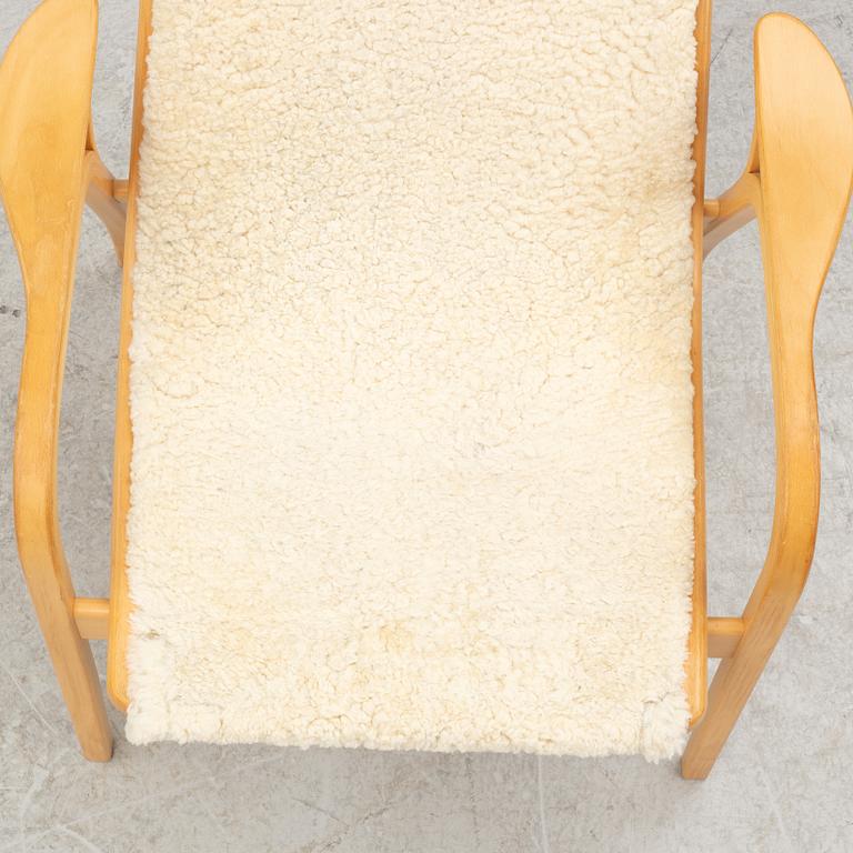 Yngve Ekström, a 'Lamino' armchair and ottoman, Swedese, 2002.