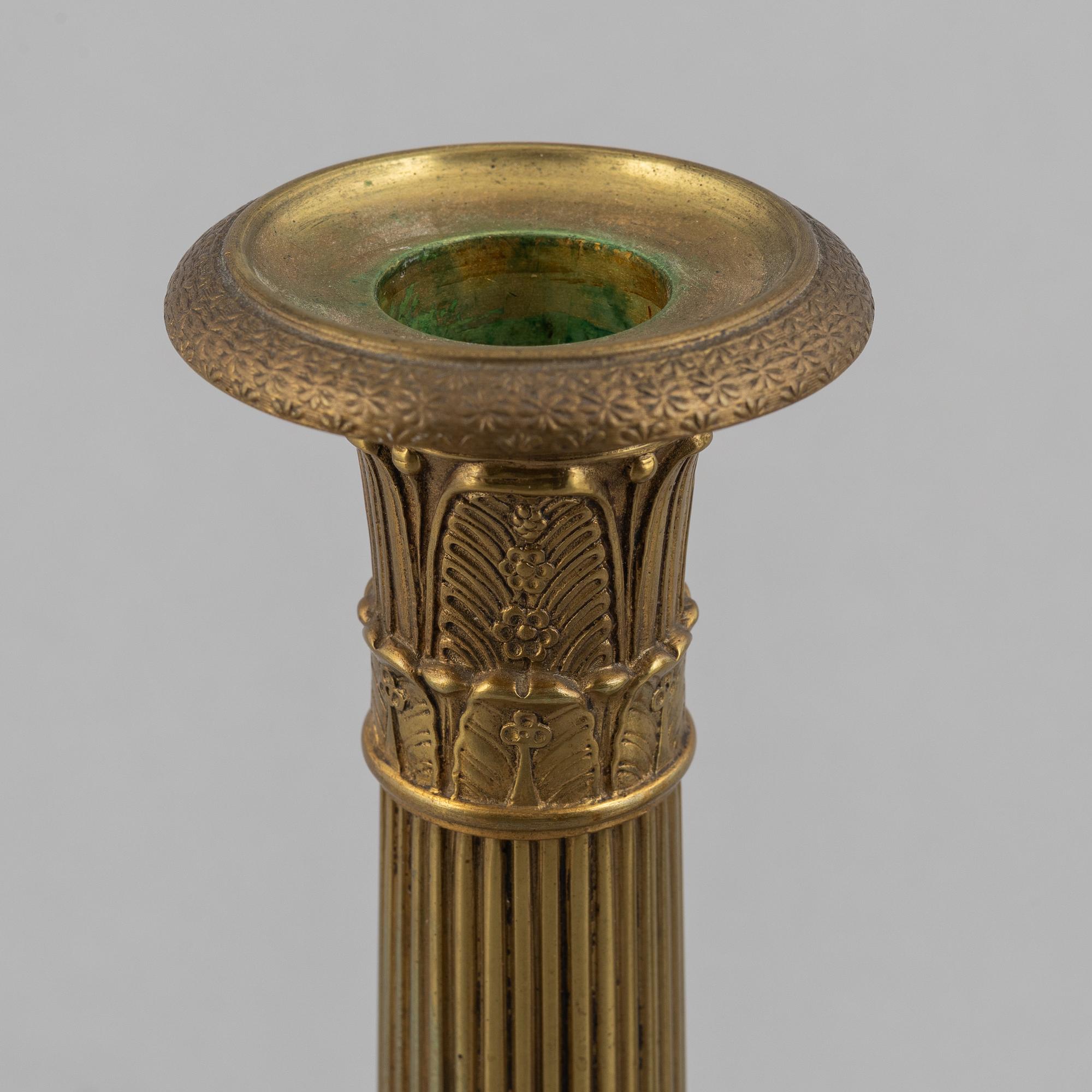A pair of Empire gilt brass candle sticks, first half of the 20th century.