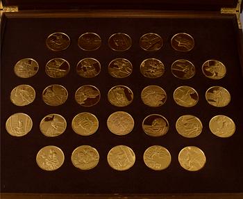 A collection of 31 gold-plated silver coins from Franklin Mint.