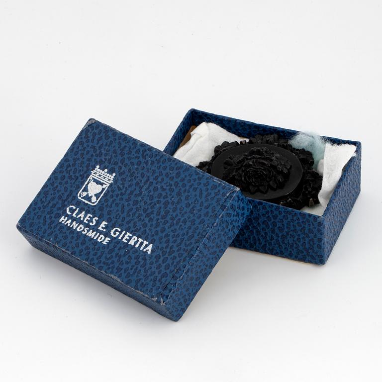 Carved possibly jet/coal and silver brooch.