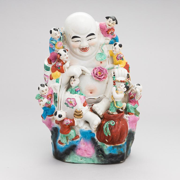 A Chinese porcelain laughing buddha with children, the 20th century.
