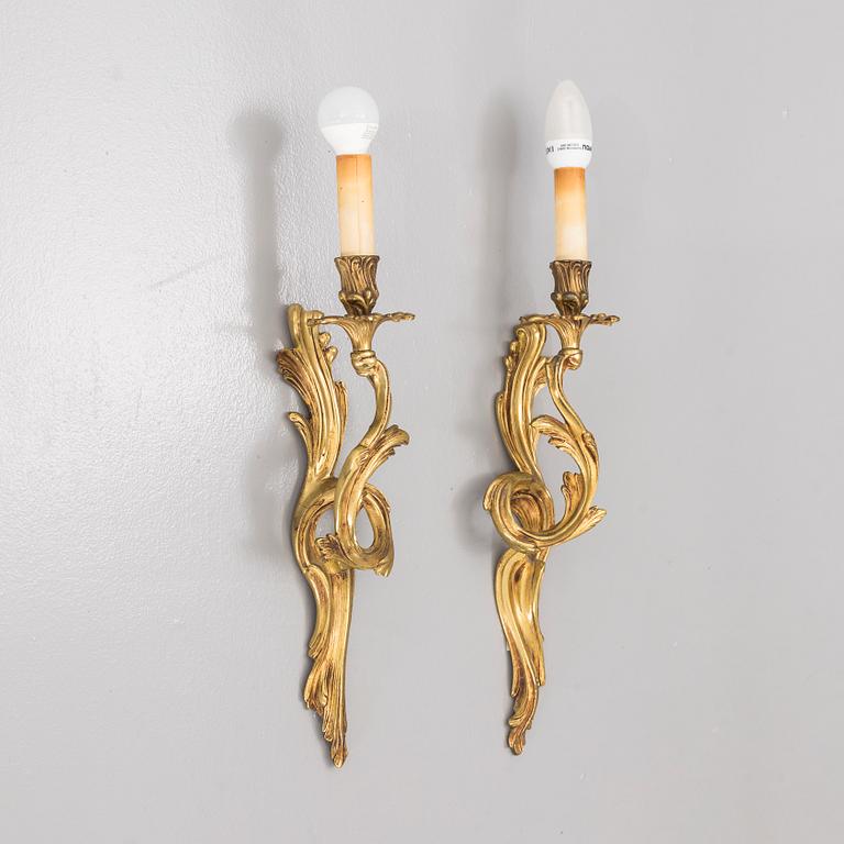 A pair of brass Rococo-style wall scones, first half of the 20th century.