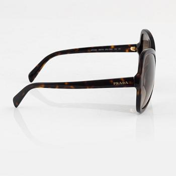 Prada, a pair of tortoise color sunglasses.
