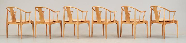 A set of six Hans J Wegner cherrywood and beige leather 'China chairs', Fritz Hansen, Denmark 1988 and 1994.
