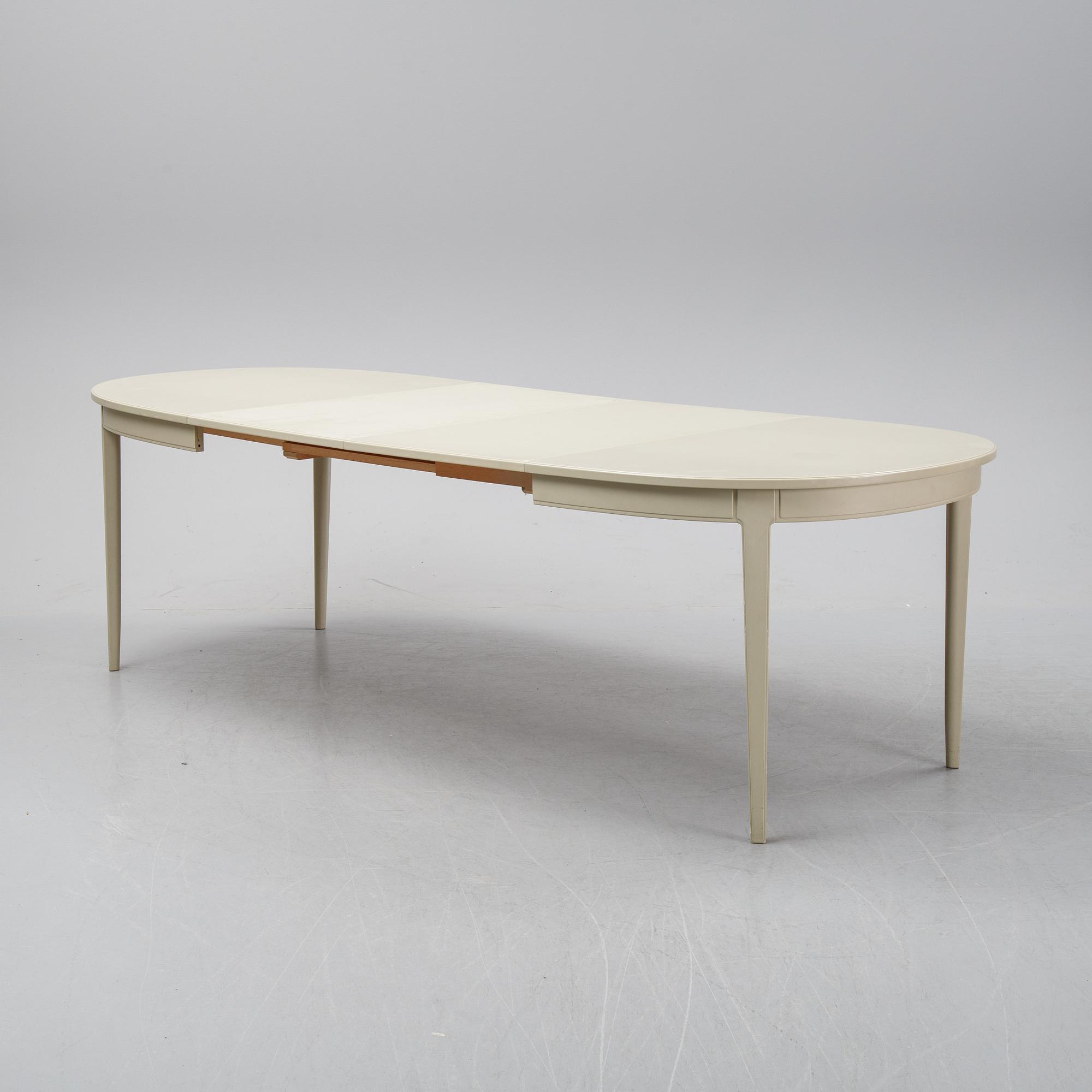 A dining table with two armchairs and six chairs by Carl Malmsten for Bodafors.