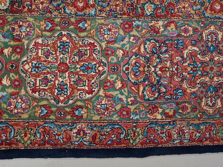 A CARPET. A semi-antique Kerman. 614,5 x 360,5 cm.