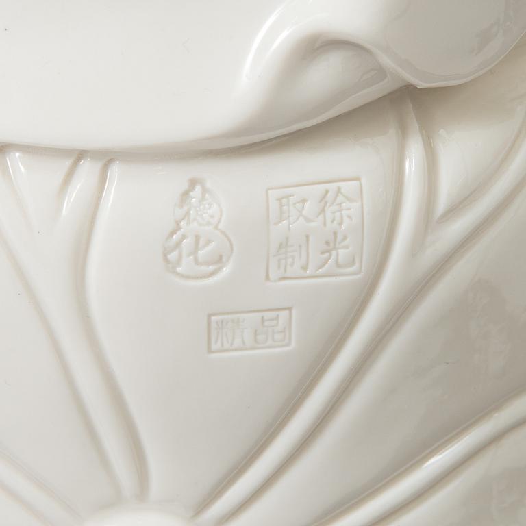 An oriental Buddha statue in porcelain.