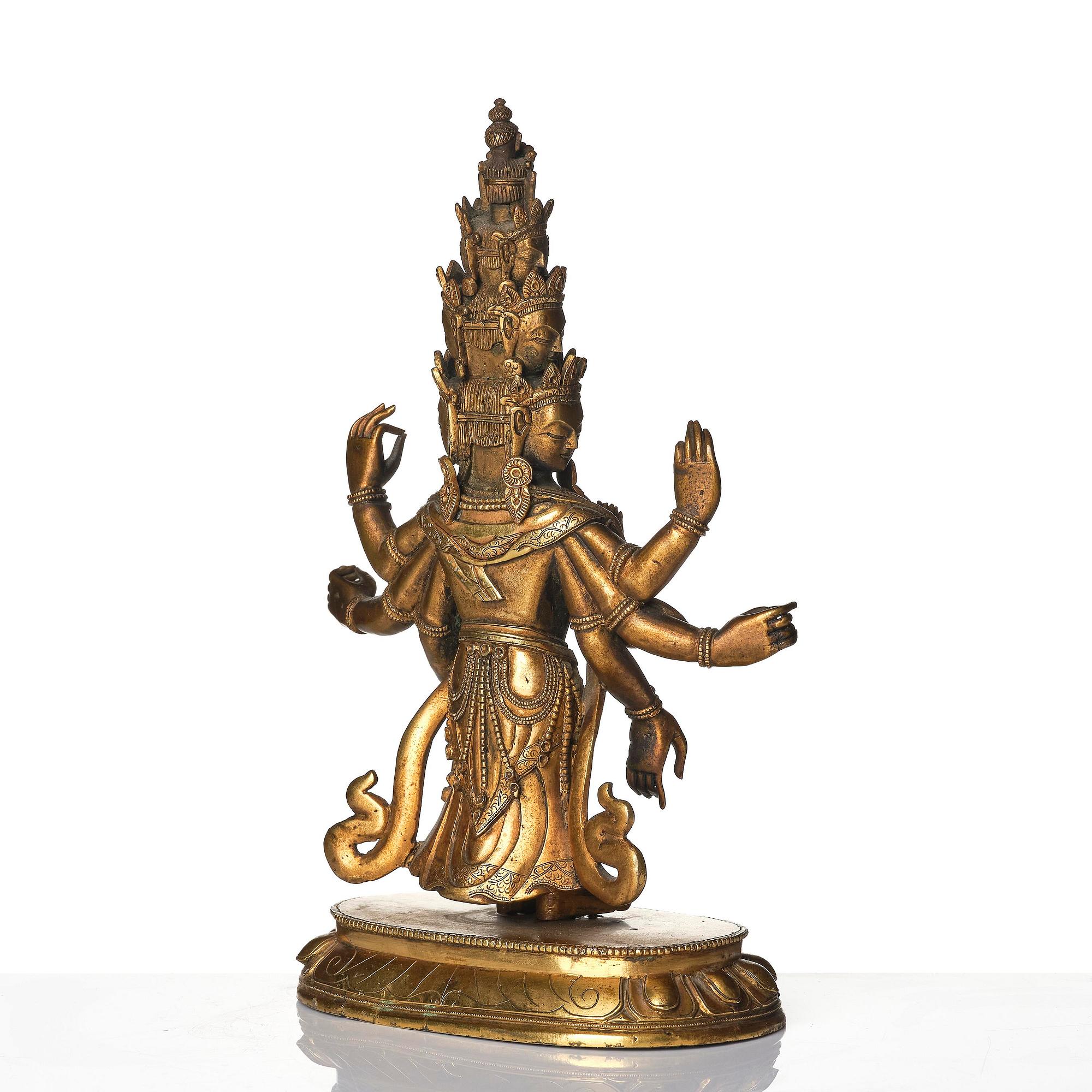 A Tibeto-Chinese gilt bronze figure of Avalokiteshvara Ekasdashamukra, 19th century.