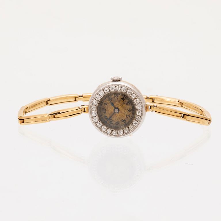 An 18K white and red gold watch set with round old cut diamonds.